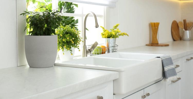 Featured image for a piece on kitchen sink dimensions featuring a 36x22 farmhouse style sink in white