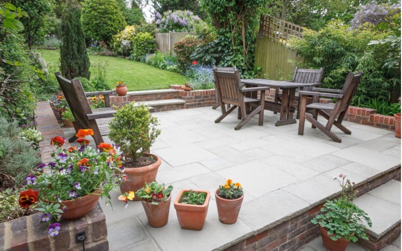 Landscaping around a concrete and stone patio in UK