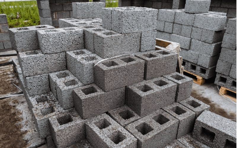 Pallets of block being used to make a cinder block house