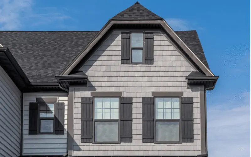 To help illustrate the types of siding available, a fancy colonial home has shake siding on the exterior
