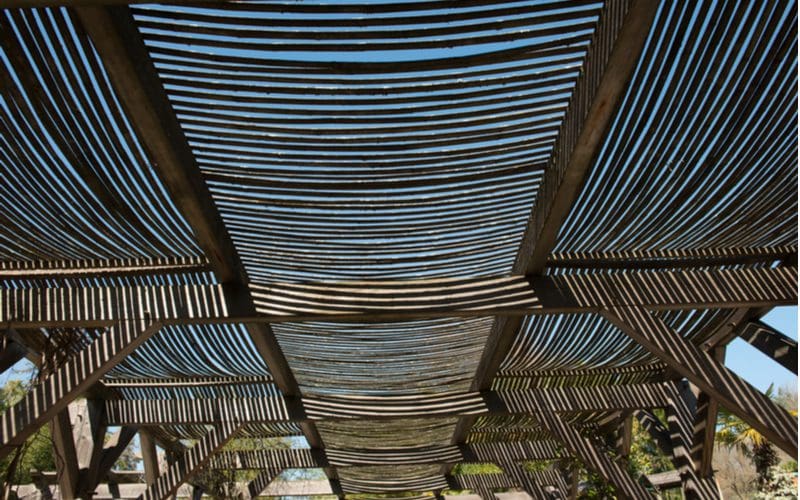 Bamboo slats sit on a wooden frame as a unique patio shade idea