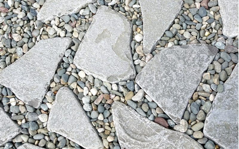 Paver patio idea with flagstone mixed with traditional river rock