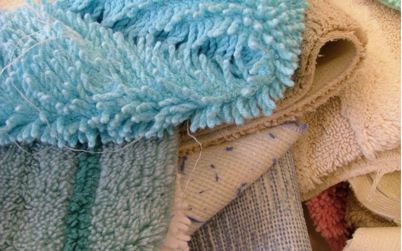 For step 4 in getting rid of carpet beetles, a number of rugs piled up