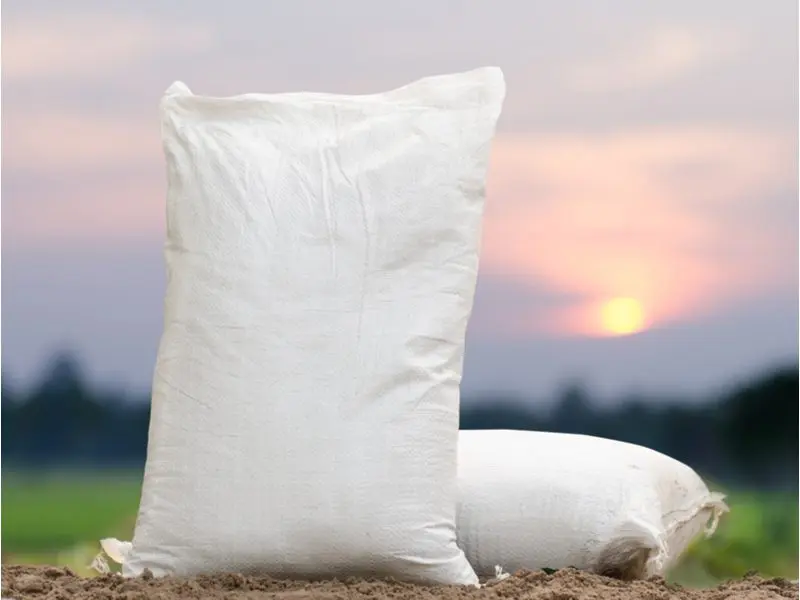 Bag of top soil that costs about $75 sitting in front of a pretty sunset