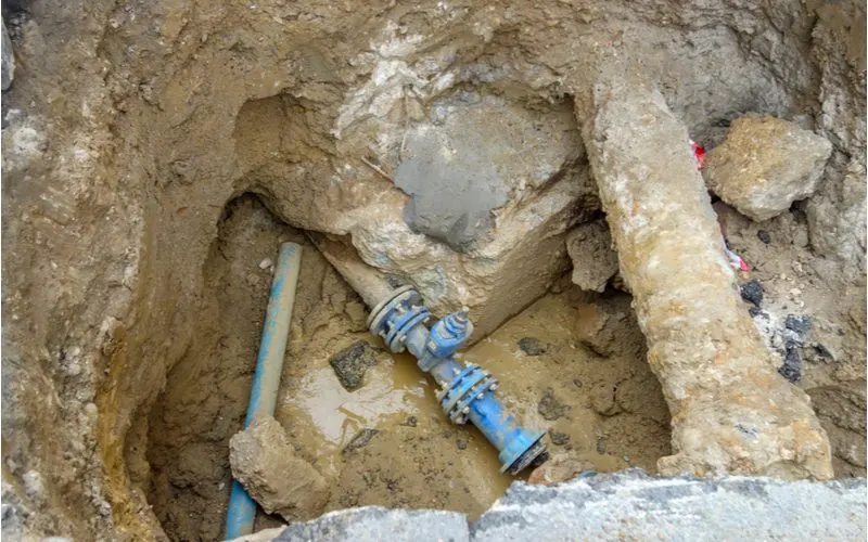 To help answer how air gets in water lines, a main water supply line is dug up and is in a pit