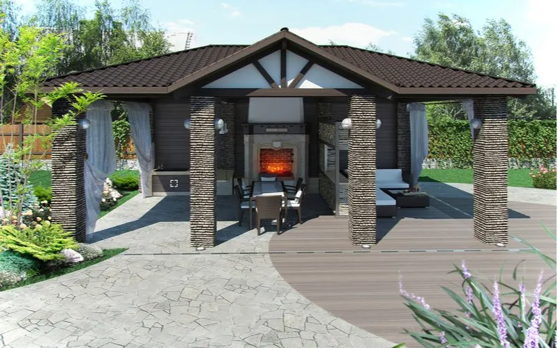 Idea for a paver patio mixed with natural other stones and wood decking in an outdoor gazebo