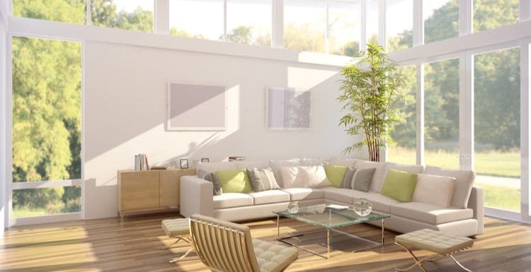 Image of a living room with bamboo flooring and a big space with tall ceilings and big windows