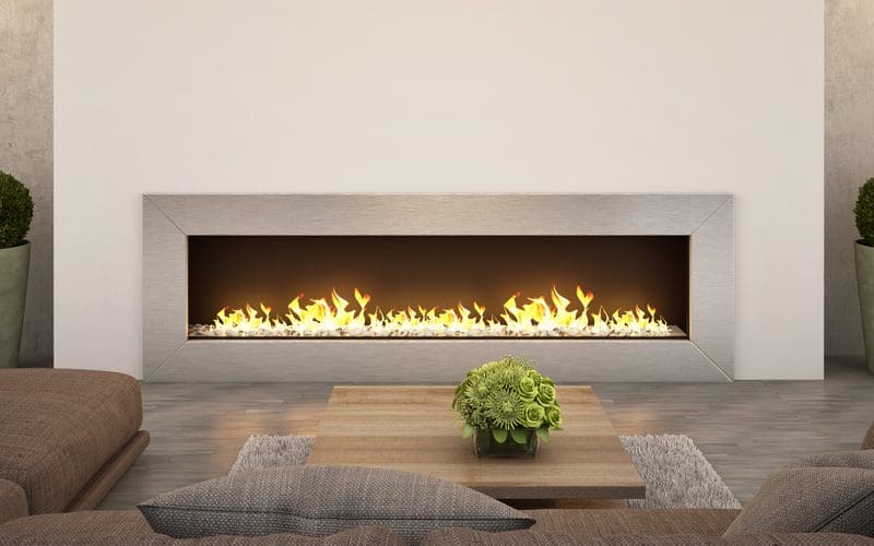 Image of a ventless gas fireplace in a huge living room with shrubs on either side of the center piece and with no mantle