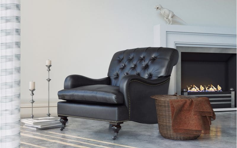 Image of a ventless gas fireplace to the right of a large leather sitting chair