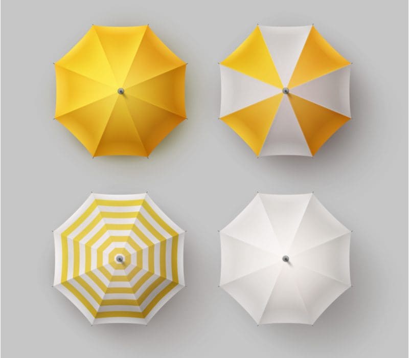 Yellow and white patio shade umbrellas above a grey background
