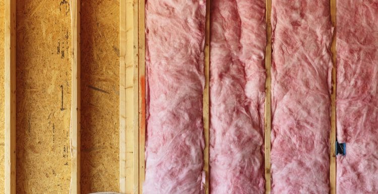 Image showing unfaced insulation in an open studded wall for a piece on faced vs unfaced insulation