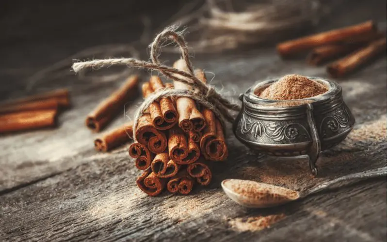 Cinnamon, a method to get rid of ants, sits on a table and in a fancy bowl