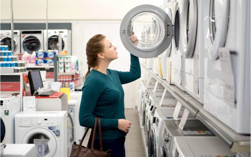 Washing machine agitator vs impeller image showing a woman shopping for a new appliance