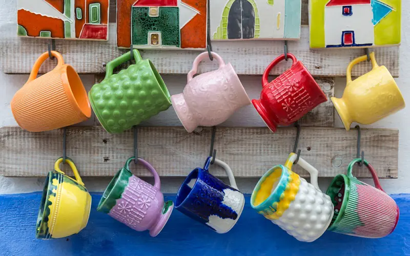 Boho styled coffee corner with colorful mugs