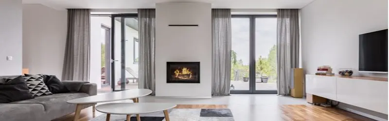 White and stark panoramic living room with a gas fireplace in the middle