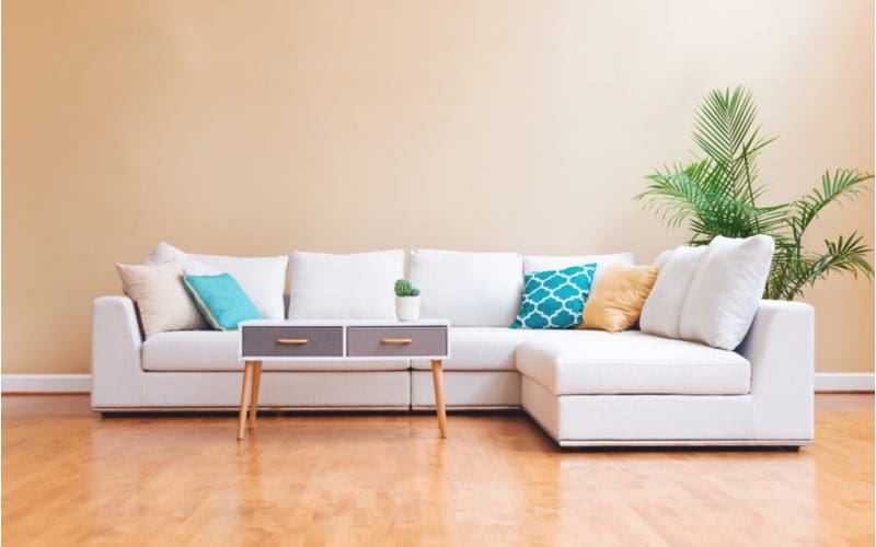 Sectional sofa displayed in a standard living room with wooden floors for a piece on average sofa dimensions
