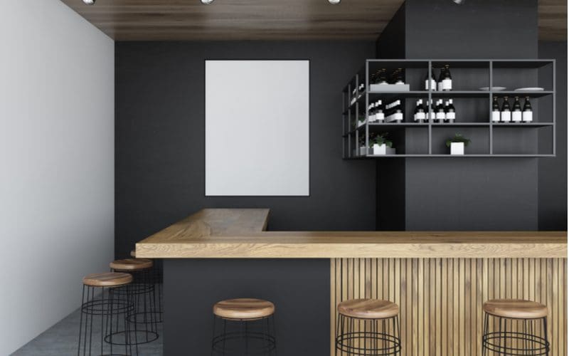 Rendering of a corner basement bar idea with wooden stools and light wooden counters