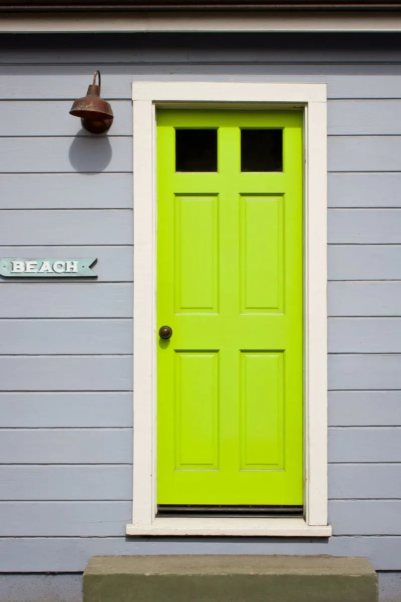 Bright green front door idea for a piece on front porch designs