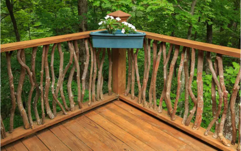 Deck railing idea featuring a natural wood railing made from thin sticks