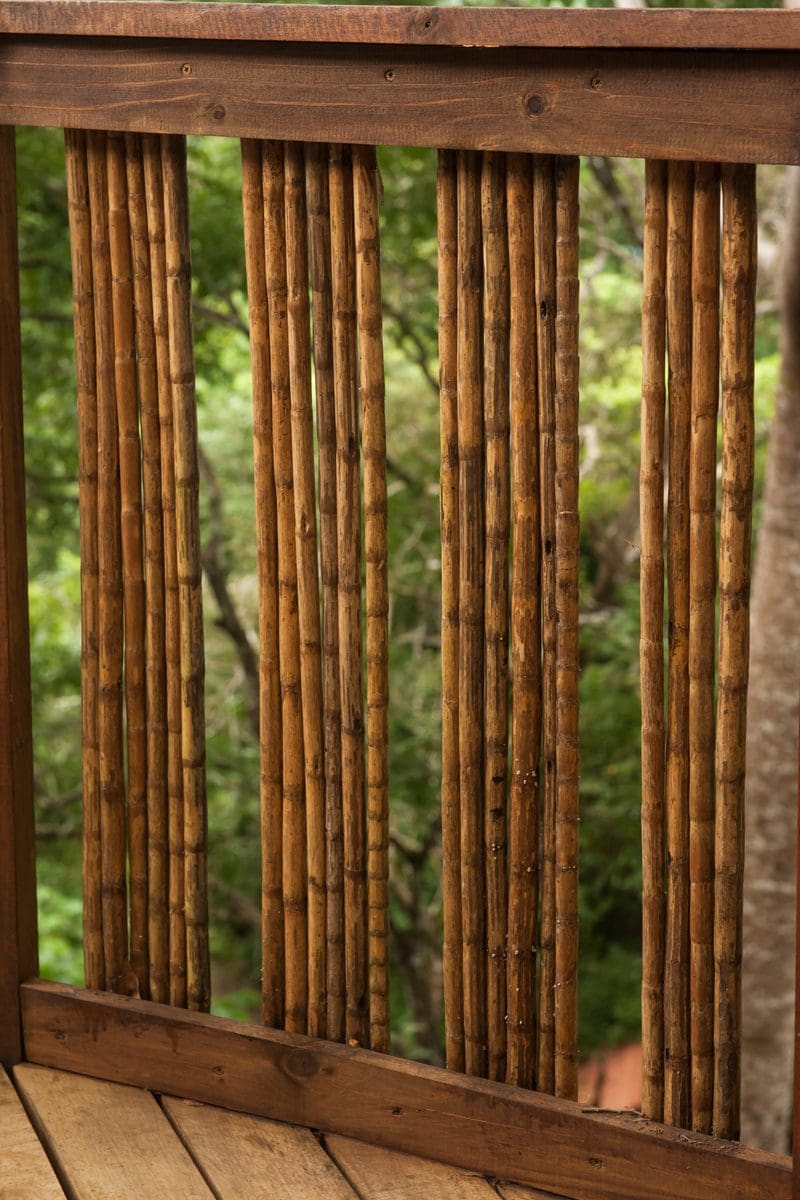 Example for a piece on bamboo deck railing ideas featuring large bamboo sticks grouped into sixes with spaces between each group