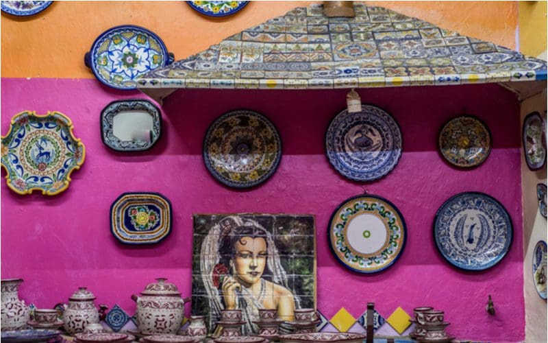 Mexican kitchen with pink and tan walls decorated with colorful plates