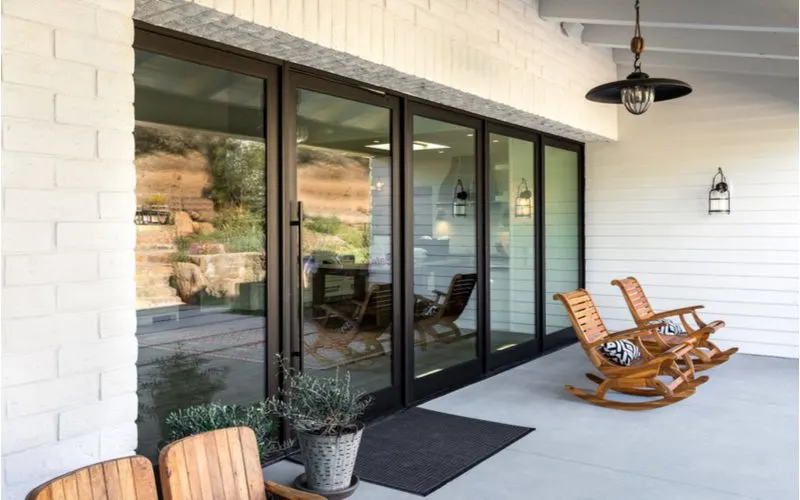 Front porch design featuring five giant floor to ceiling windows that brings the interior of the home outside