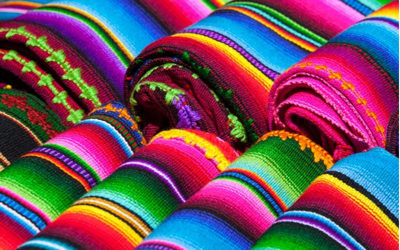 Colorful blankets in the Mexican style in pink and yellow and red colors