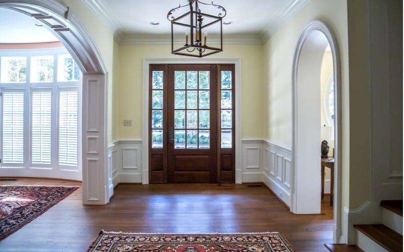 Paneled archway wainscoting idea in a half-wall décor idea with beige painted walls above