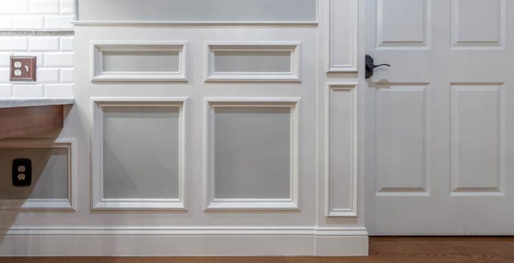 For a piece on wainscoting ideas, a white panel molding above a light brown wood floor