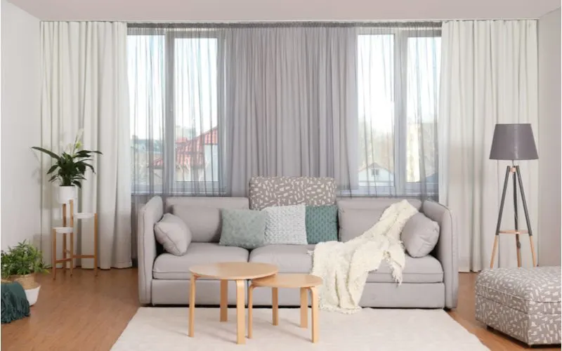 Living room with standard sized curtains hanging on either side of the big picture window