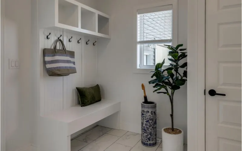 Photo of a standard size mudroom bench in a room painted all white
