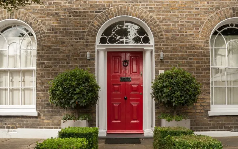 An example of red door ideas on a brick house in London