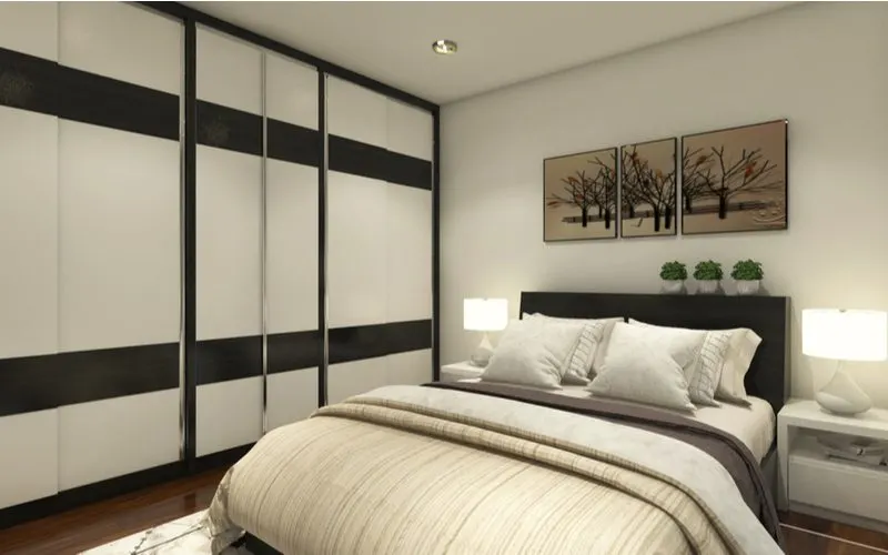 Image for a piece on average bedroom size featuring a hotel room with modern white walls and dark trim