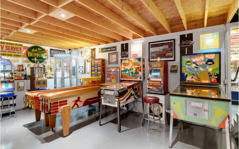 Idea for basement with a bunch of arcade games sitting in the open on a polished concrete floor