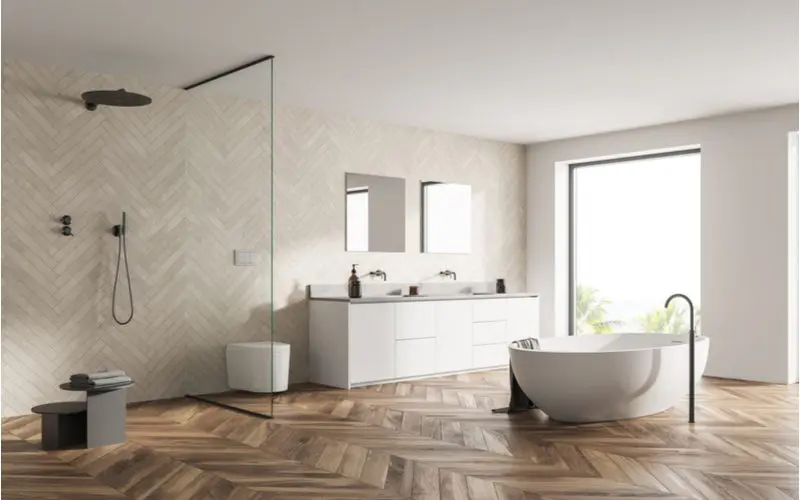 Example for a roundup on walk-in shower ideas with a glass-walled walk in shower with a raised tub on herringbone wood tile