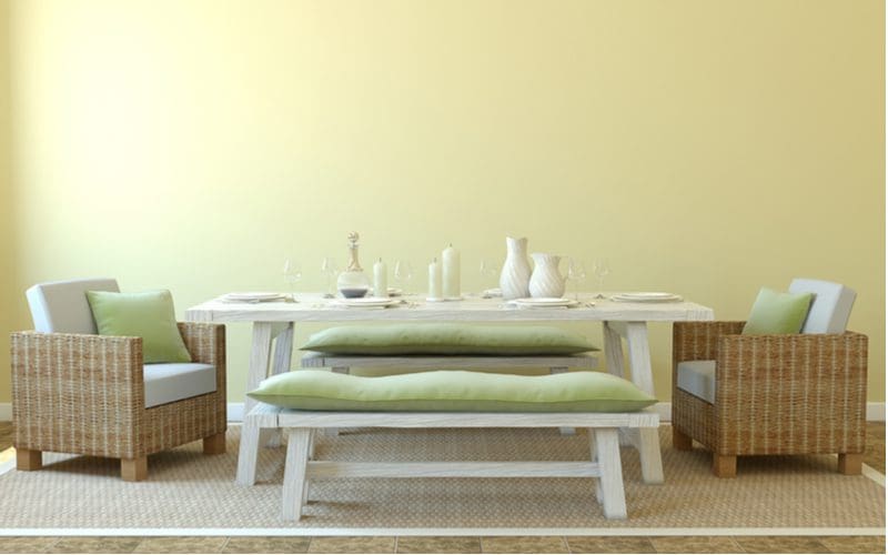 For a piece on standard bench sizes, a nice dining room with wicker chairs and a rustic-looking wooden bench