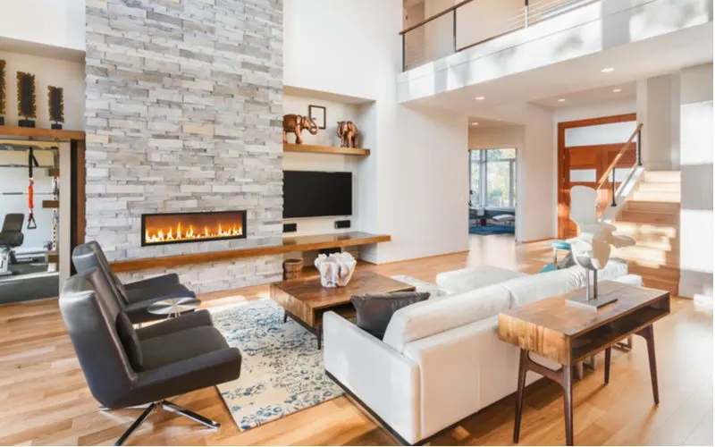 Gorgeous living room with a fireplace in the middle in the middle of an open-floorplan house
