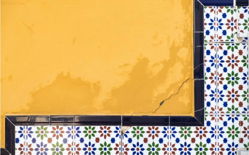 Mexican kitchen inspiration showing colorful floral subway tile on a bright orange wall