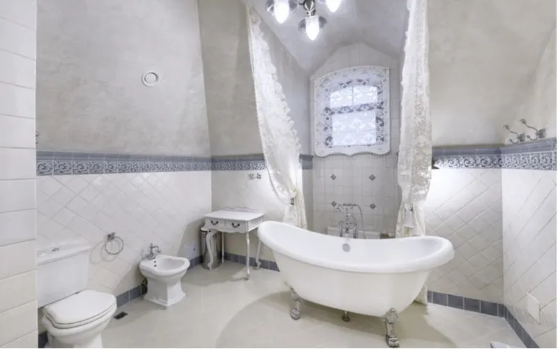 Bathroom idea titled pastel dream with vaulted ceilings, a bidet, and victorian-era furniture