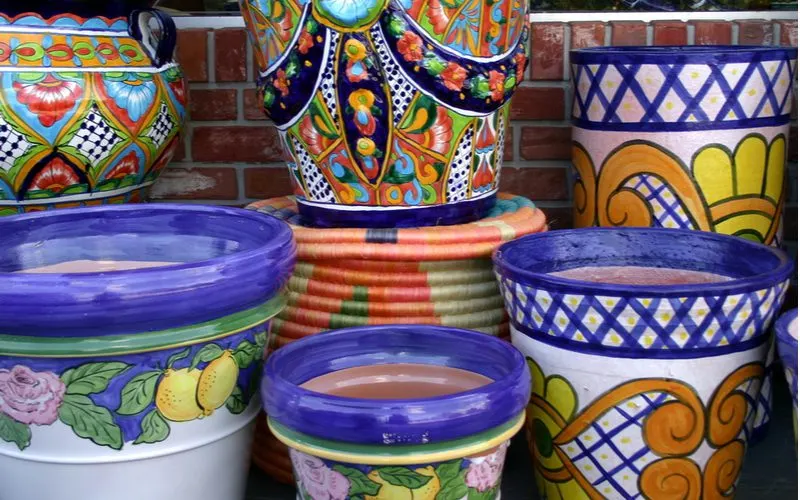 Talavera pottery pieces stacked on top of one another in a big pile