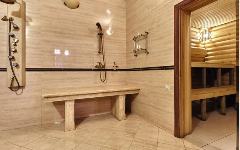 Photo showing a standard bench sized bench in a shower next to a sauna