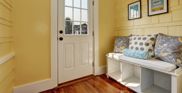 For a piece on average bench sizes, a show storage bench in a mud room that's been painted yellow