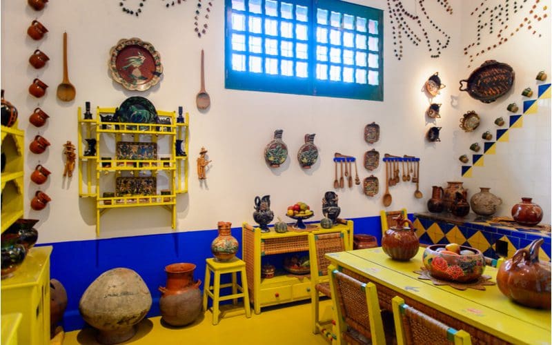 Photo of the walls of a traditional Mexican kitchen, showing lots of decorations all over the entire wall space