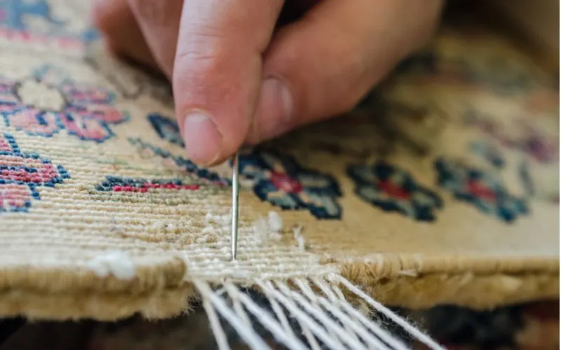 For a piece on where to get a rug cut and bound, a woman with a needle doing just this