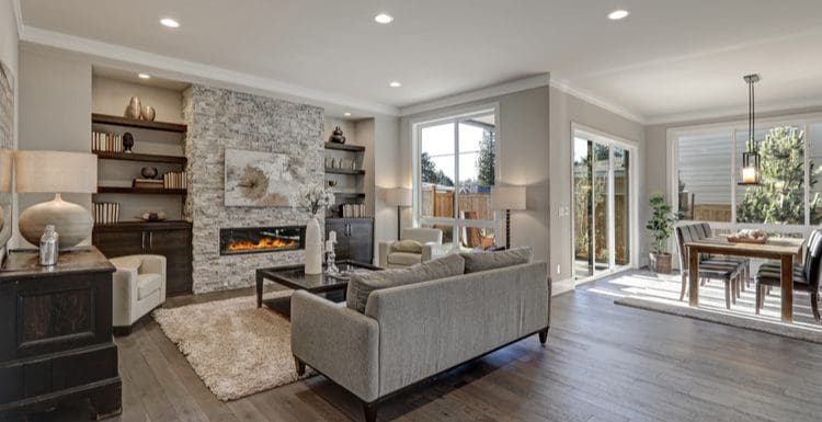 Featured image for a piece on what color carpet goes with grey walls featuring a grey walled living room