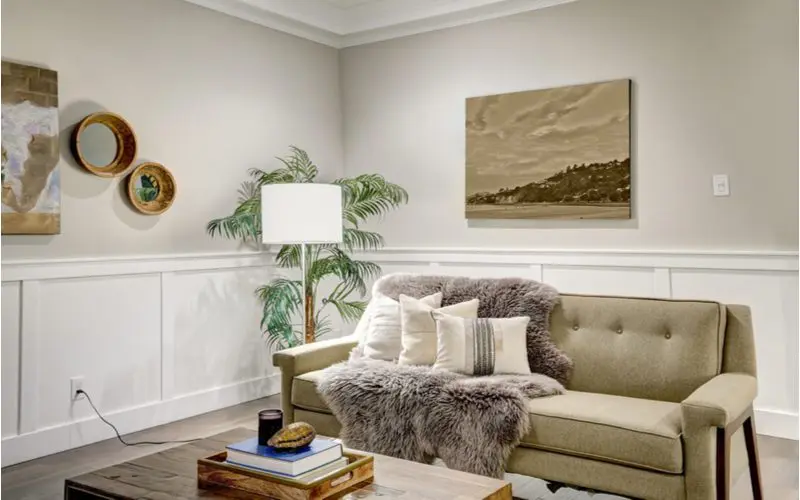 Craftsman wainscoting idea in a simple room with a brown couch with brown wall accents