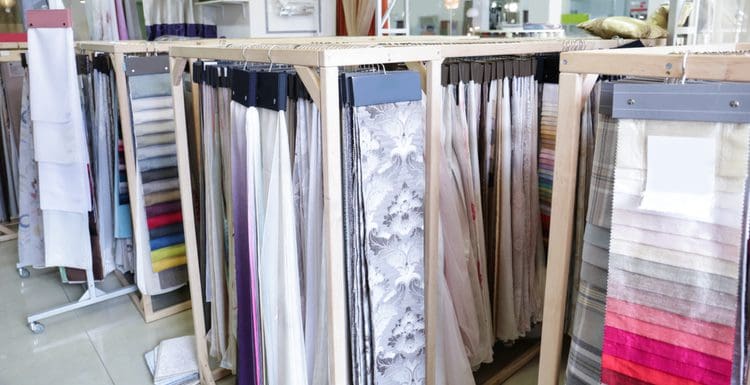 For a piece on standard curtain sizes, a bunch of fabric curtains hang in a showroom