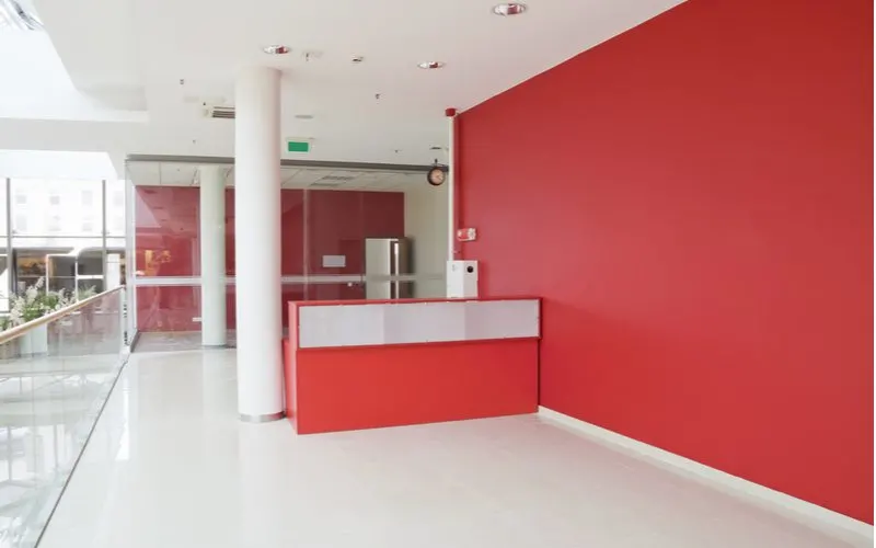 Image of a red wall in an office hallway to symbolize the types of paint you can use