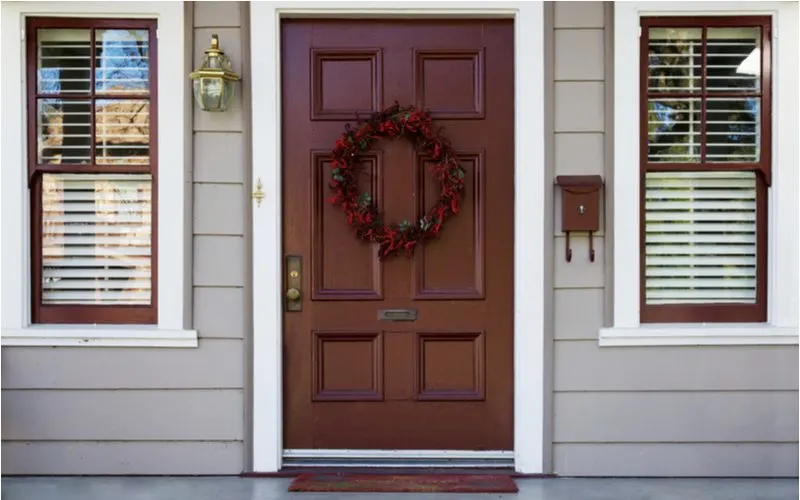 Burgundy red door idea surrounded by white trim