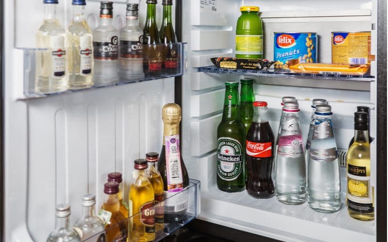 Image of a basement bar minibar stocked with foreign-made beverages